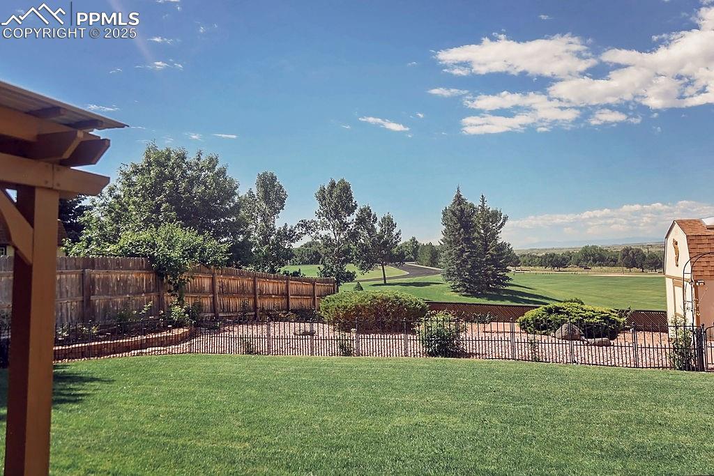 Image 43 of 50: Fully Landscaped & Fenced Backyard