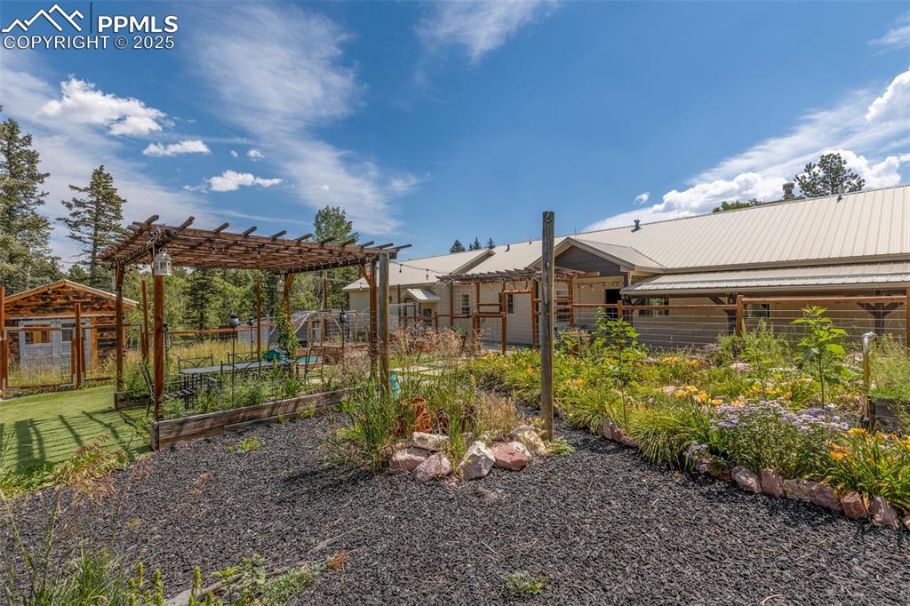 Image 46 of 50: Beautifully enclosed flower garden with a tranquil sitting area