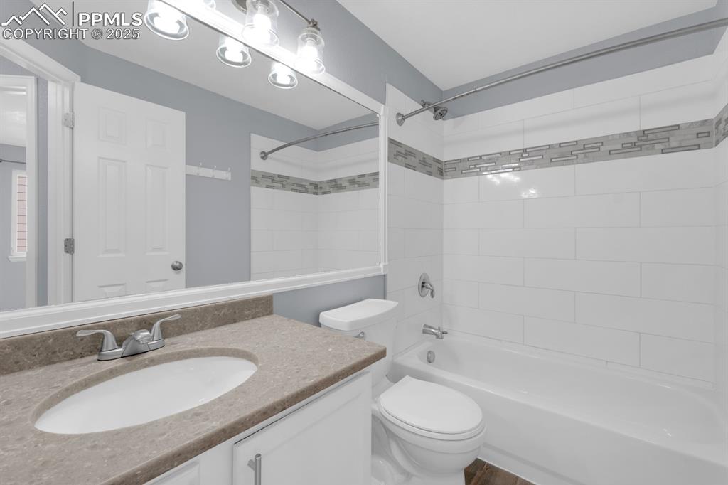 Image 19 of 36: Upper Guest Bathroom featuring updated tile/countertop