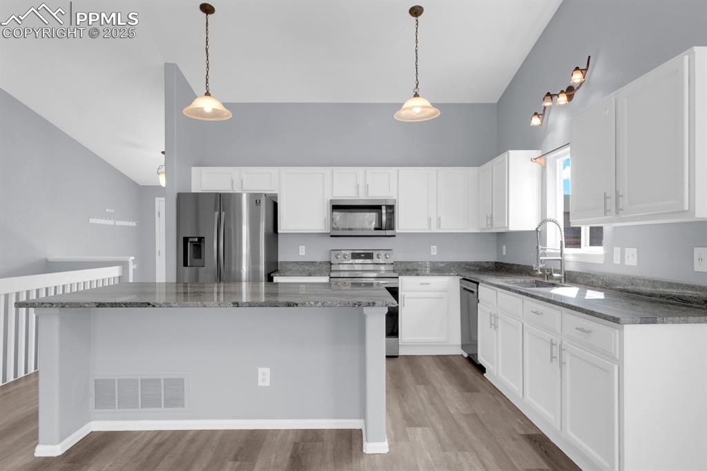 Image 8 of 36: Kitchen featuring stainless steel appliances, light wood style floors, and