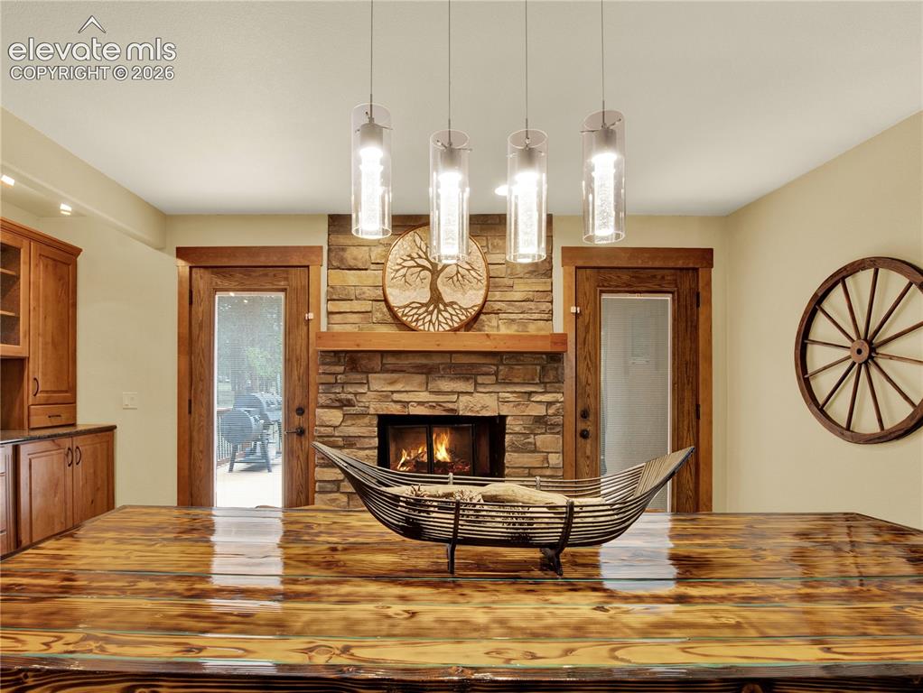 Image 16 of 43: Formal dining room warmed by a wood burning with access to an outside patio