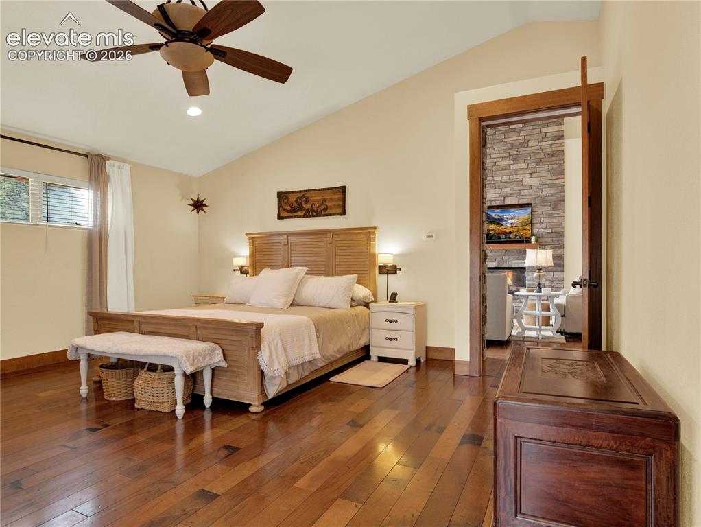 Image 18 of 43: Primary bedroom comes with vaulted ceiling and beautiful hardwood flloors