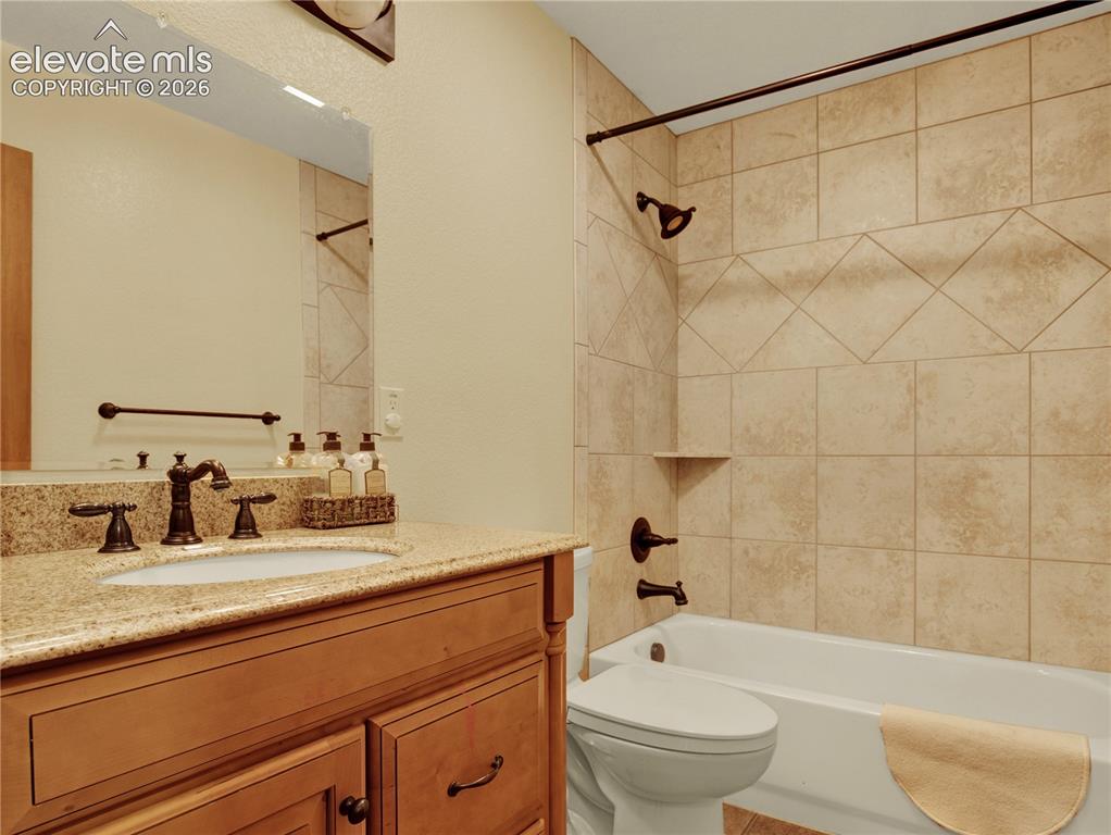 Image 29 of 43: Additional full main level bathroom located between the laundry room and th