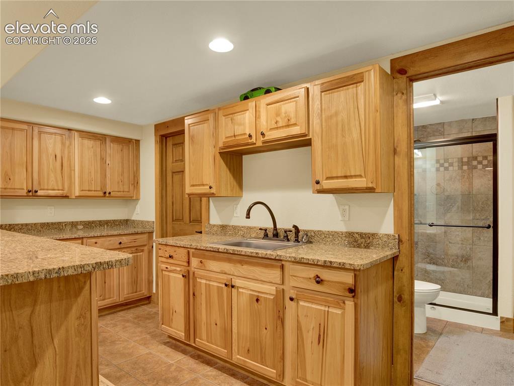 Image 32 of 43: Full Wet bar followed by a 3/4 bathroom