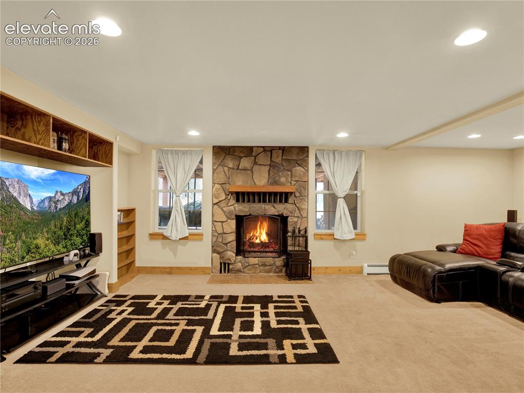 Image 34 of 43: Family room space beyond the bar area for lounging in front of the TV and w