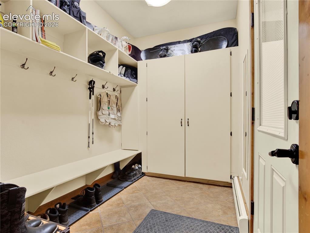 Image 36 of 43: Full large mud room located between the lower level entertainment area and