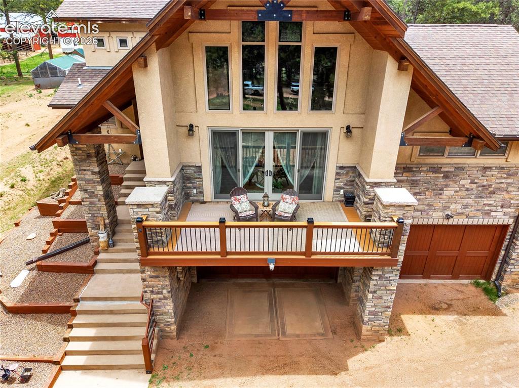 Image 37 of 43: Looking down on the front deck that walks out from the living room