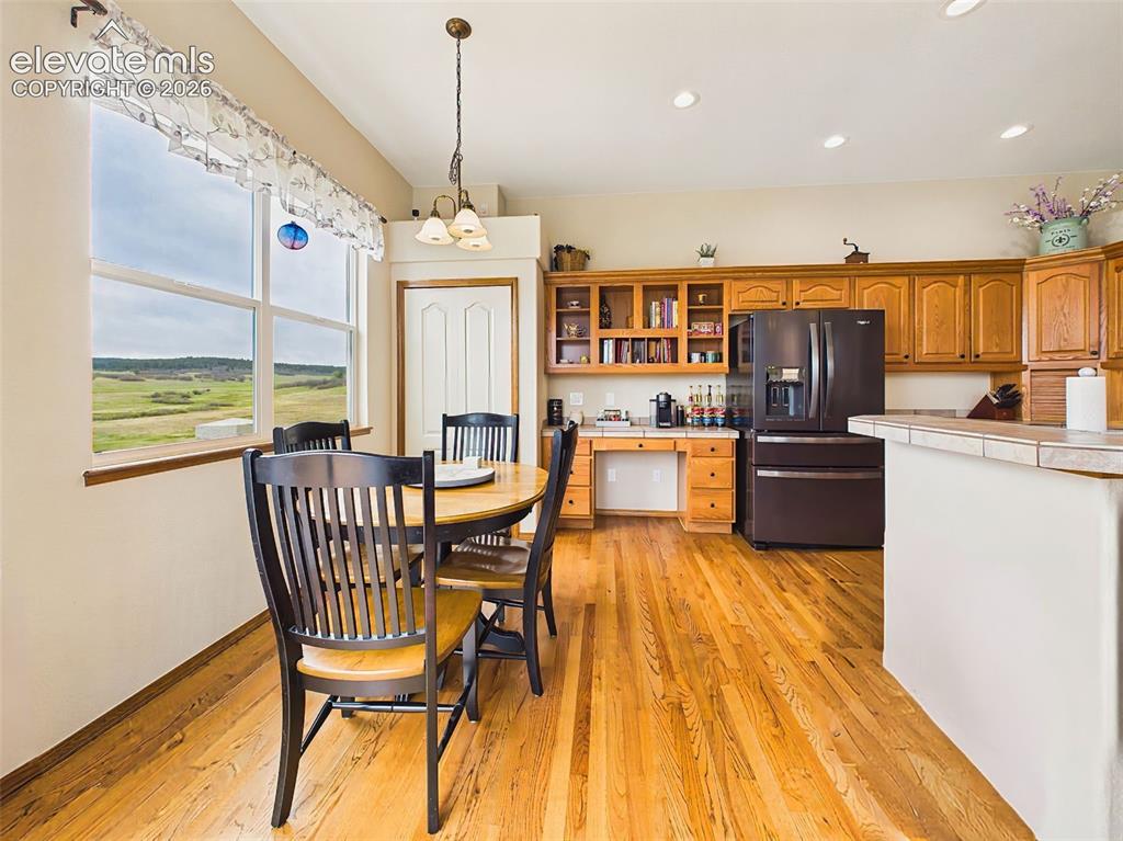 Image 10 of 50: Bright breakfast area with large picture windows and peaceful views, offeri