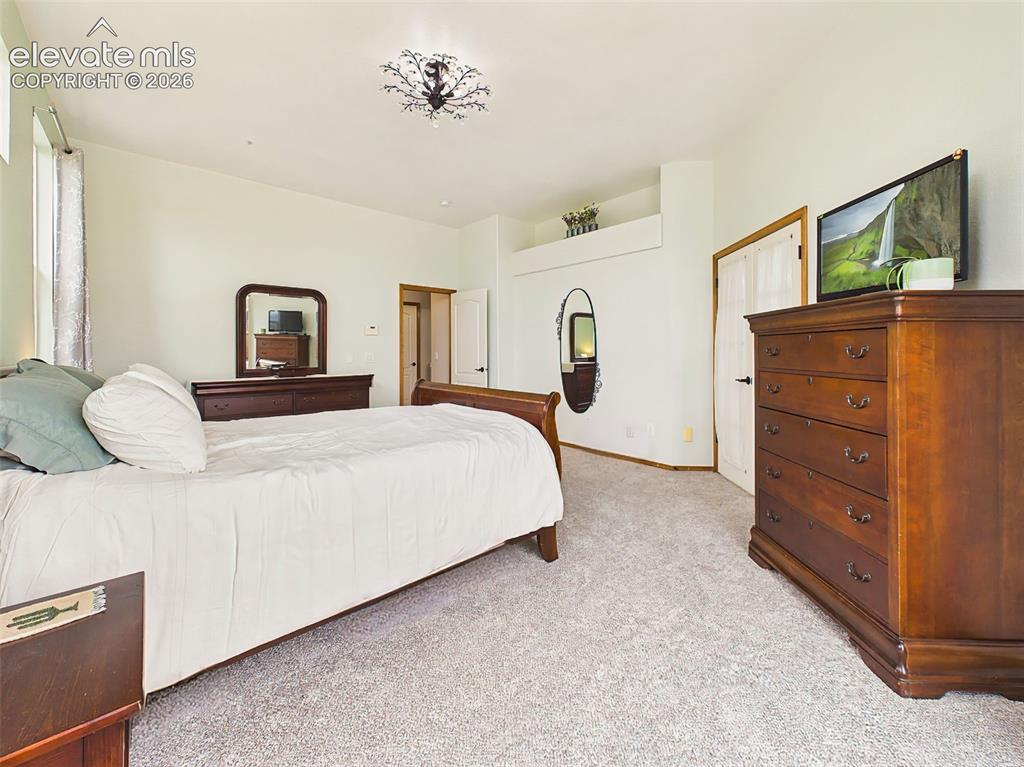 Image 17 of 50: Comfortable primary retreat with generous room dimensions, soft natural lig