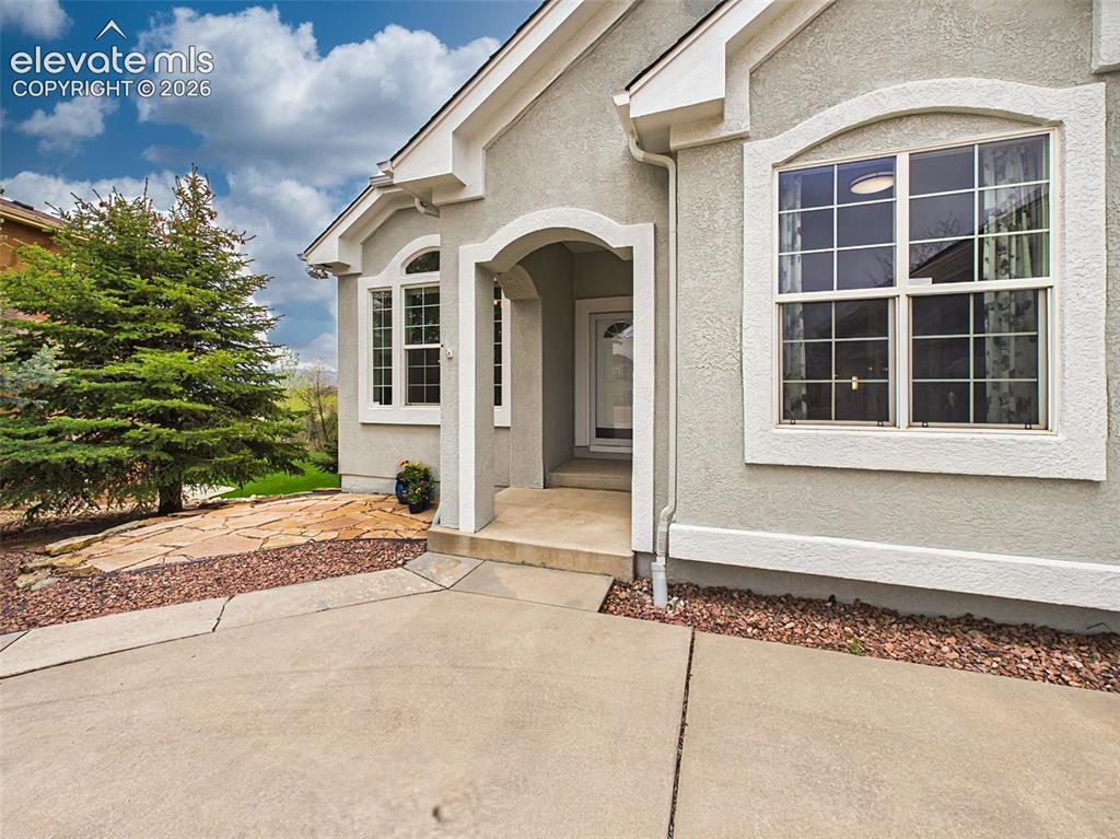 Image 2 of 50: Welcoming covered front porch featuring elegant arched architectural detail