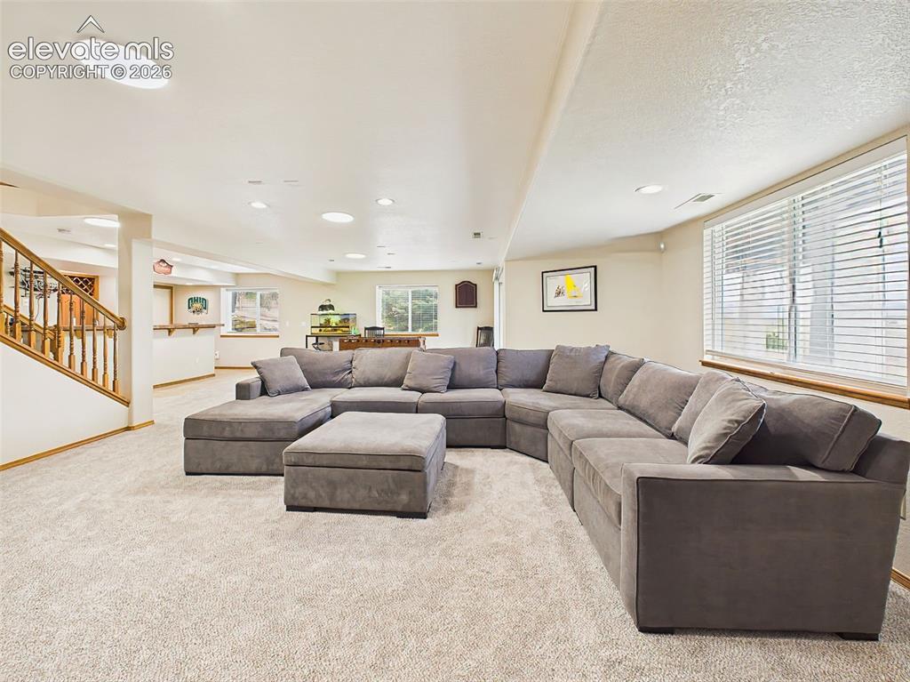 Image 29 of 50: Comfortable family room with oversized sectional seating and abundant reces