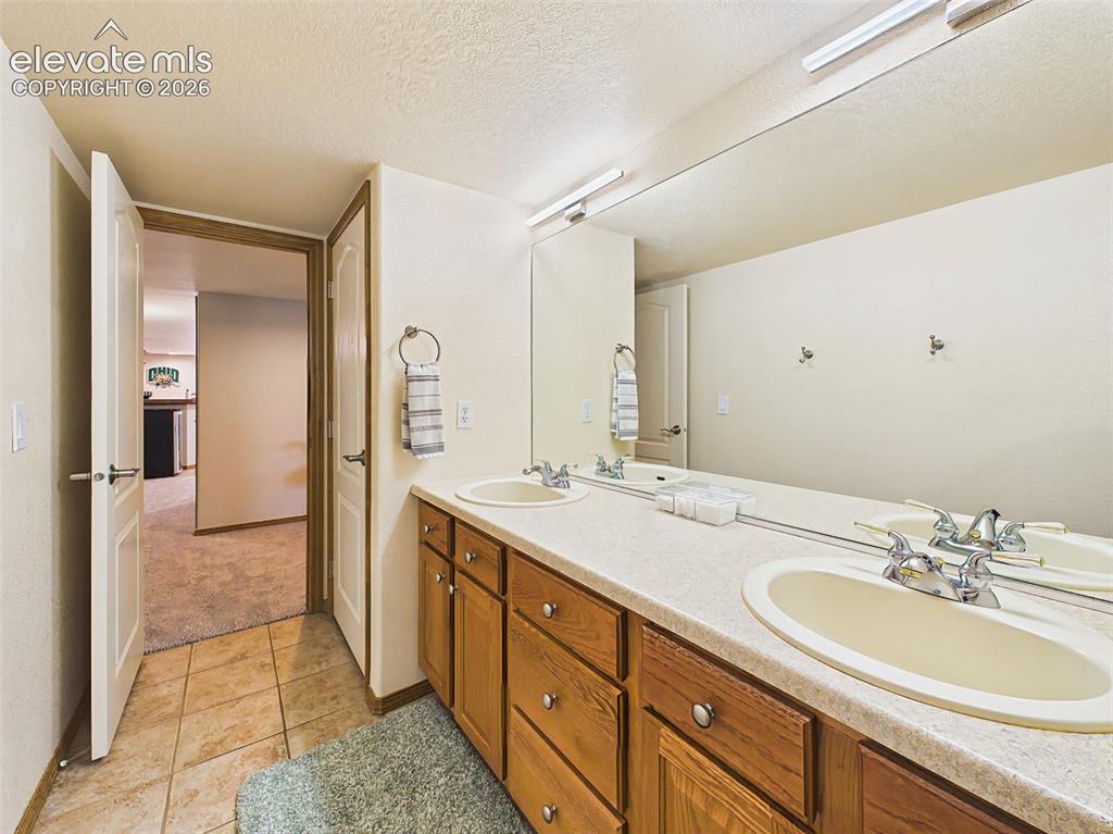 Image 35 of 50: Well-appointed full bathroom with dual-sink vanity, abundant cabinet storag