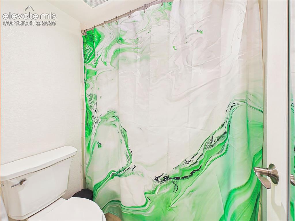 Image 36 of 50: Secondary full bath complete with a shower/tub combination and neutral fini