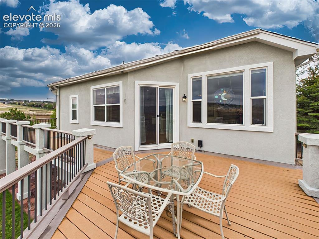 Image 39 of 50: Spacious outdoor deck with direct access from the kitchen, ideal for relaxi