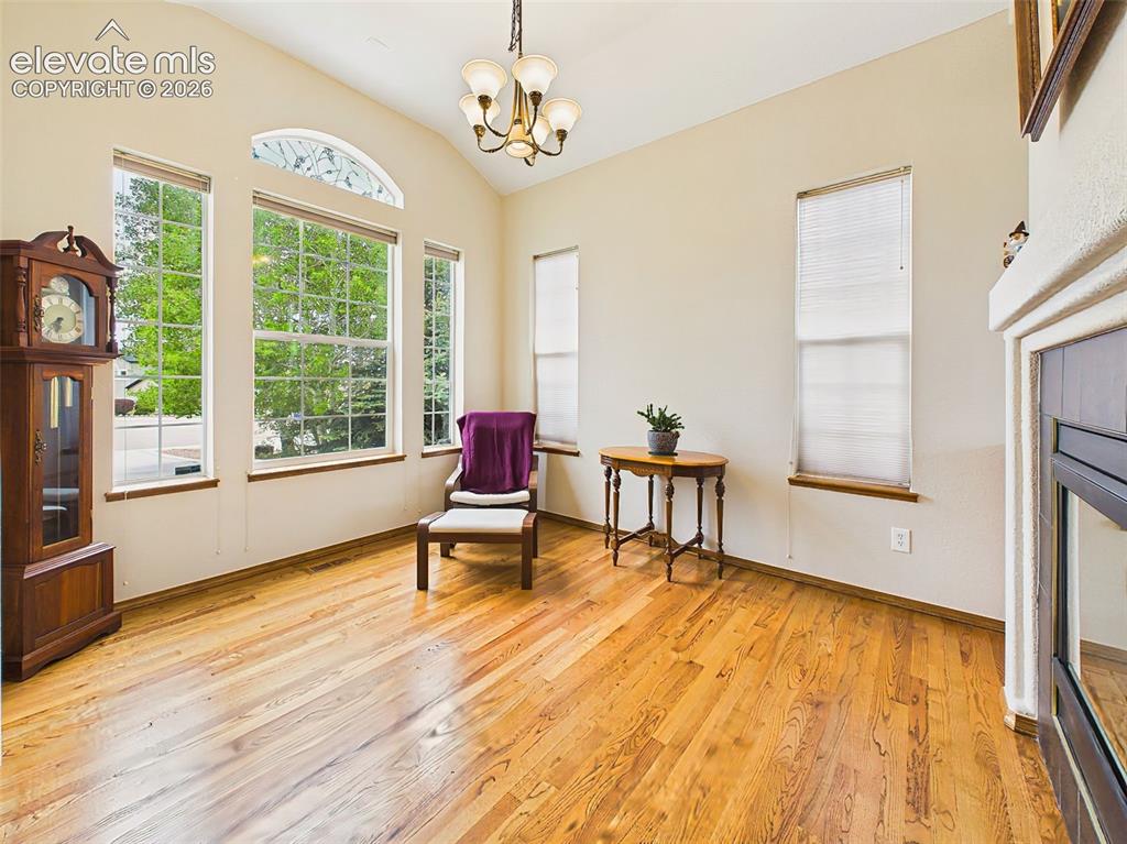 Image 4 of 50: Sunlit sitting area could be formal dining featuring vaulted ceilings, over