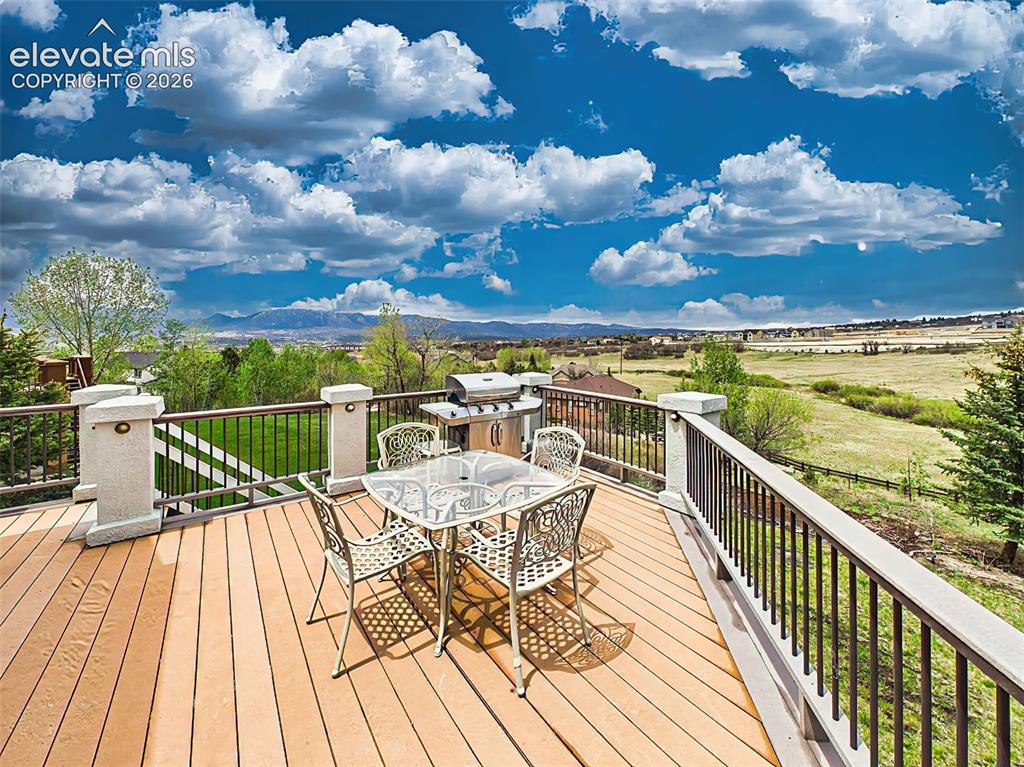 Image 40 of 50: Elevated deck designed for entertaining with panoramic views of rolling ope
