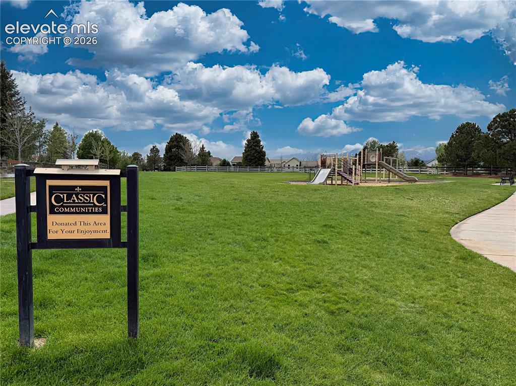Image 49 of 50: Expansive neighborhood park featuring walking paths, playground equipment,