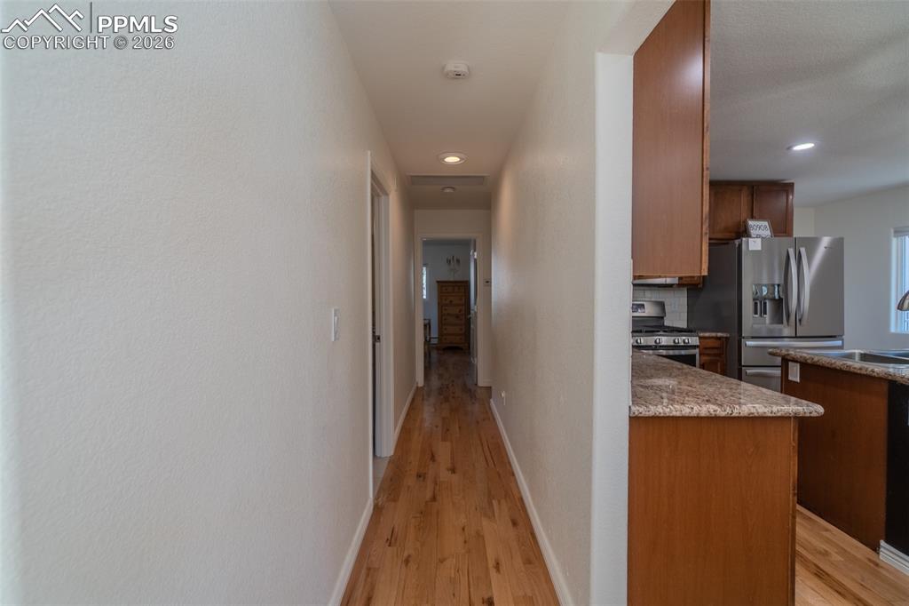 Image 16 of 50: Corridor with light wood-type flooring and recessed lighting