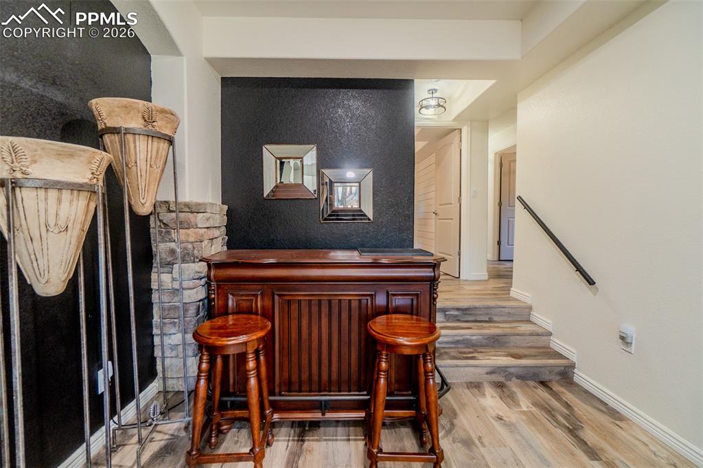 Image 27 of 50: Couple of stairs to three beds and laundry room