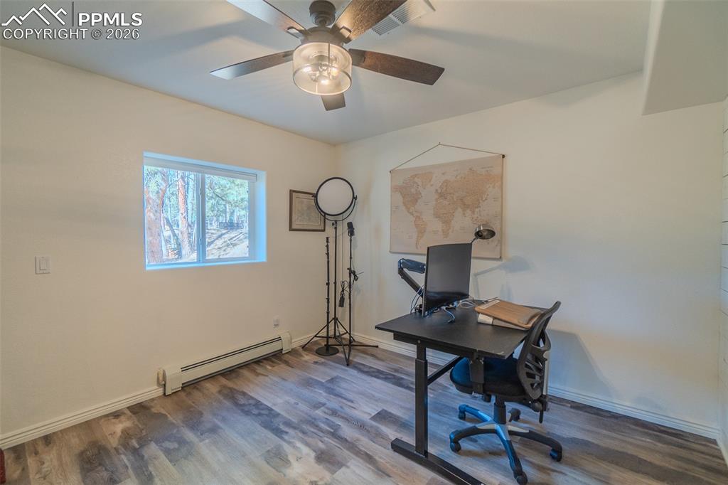 Image 33 of 50: 5th lower level bedroom currently used as office.