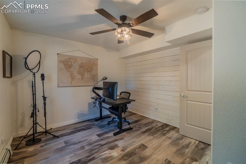 Image 35 of 50: Currently used as a Home office with wood finished floors, a baseboard heat