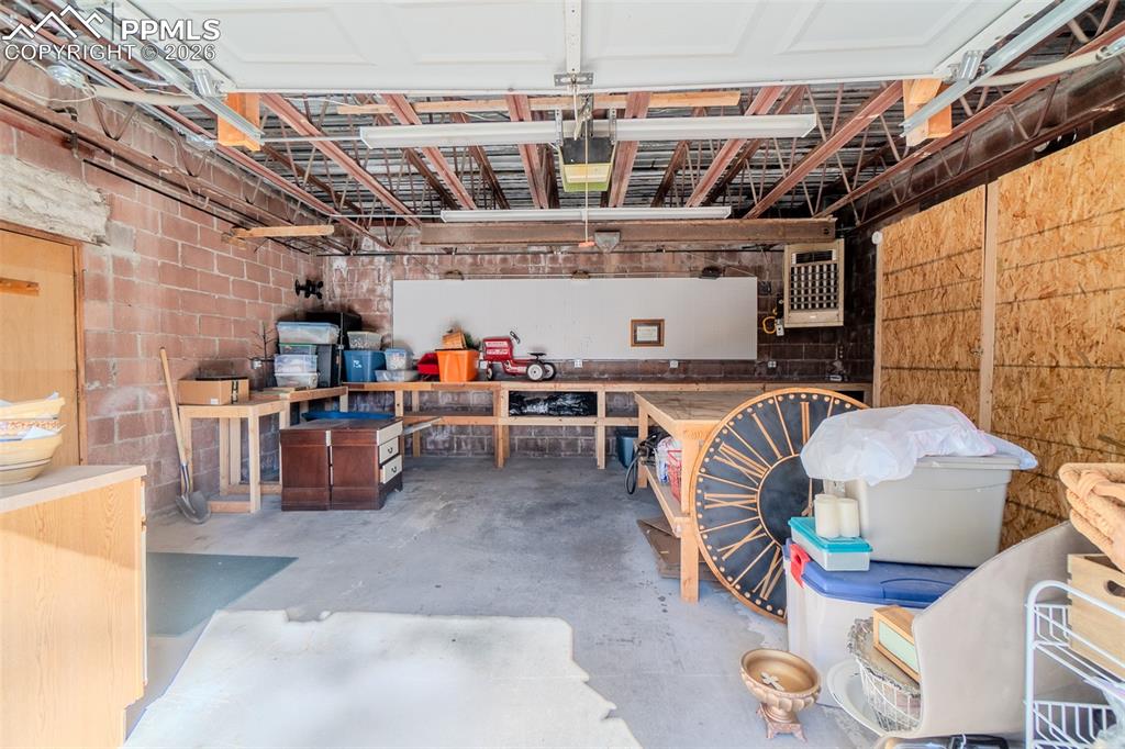Image 46 of 50: Garage featuring a heating unit, painting bay and tons of counters and stor