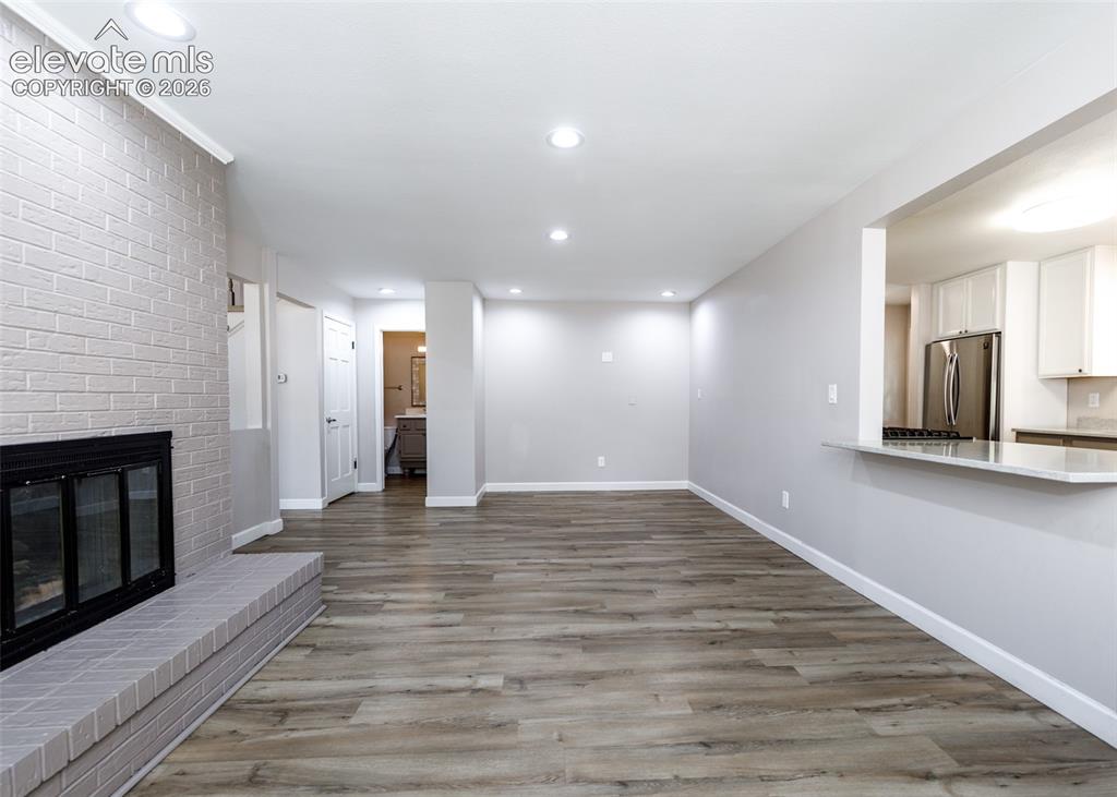 Image 16 of 44: Wood-finish flooring throughout, complemented by recessed lighting