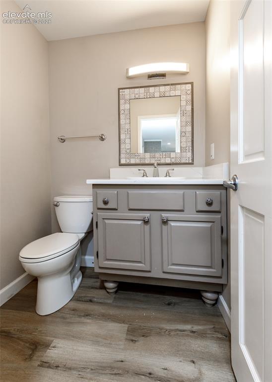 Image 17 of 44: Gray vanity with white countertop and integrated sink, mosaic-framed mirror