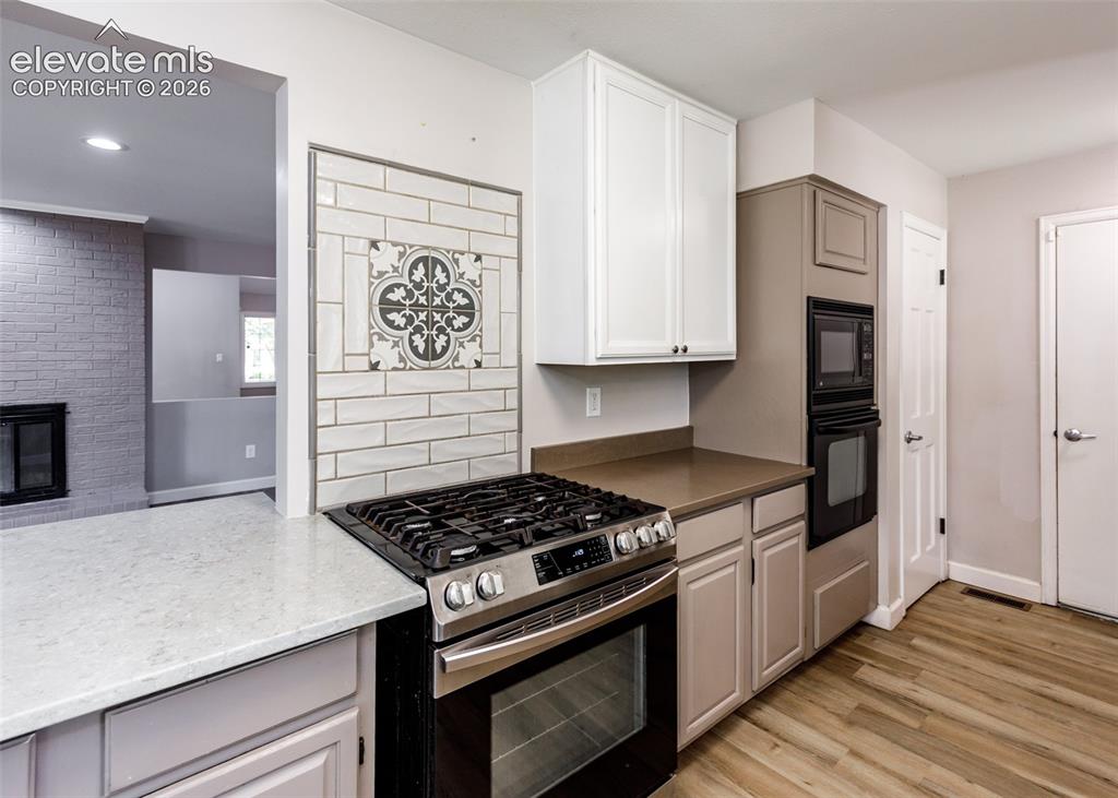 Image 21 of 44: Stainless steel gas range, built-in oven, and built-in microwave