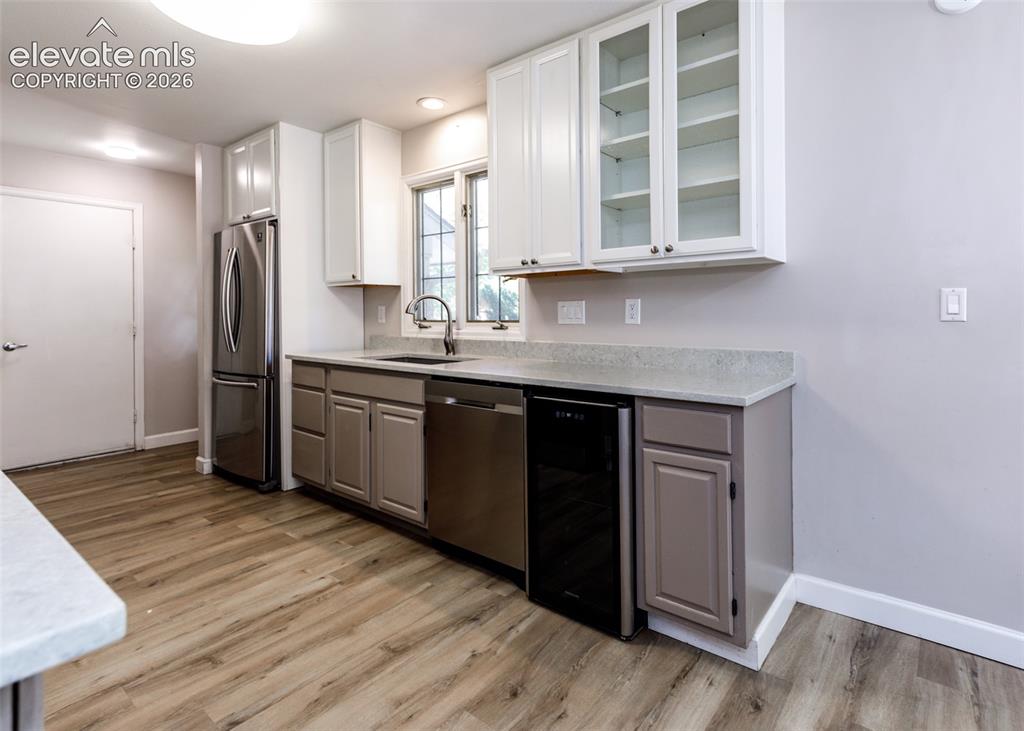 Image 22 of 44: Kitchen featuring stainless steel appliances, light-toned wood-finish floor