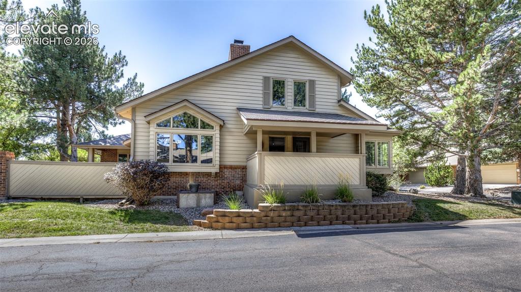 Image 3 of 44: Traditional-style residence featuring light-colored siding and a brick-fini