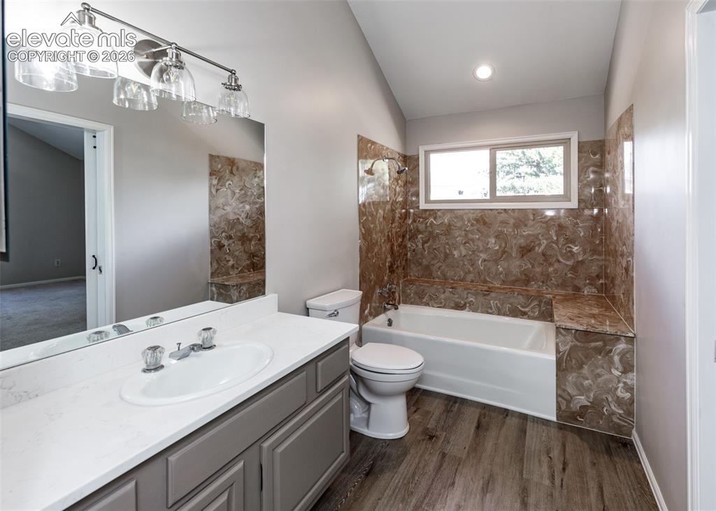 Image 33 of 44: Vanity with a single basin, brushed nickel faucet, and a large mirror