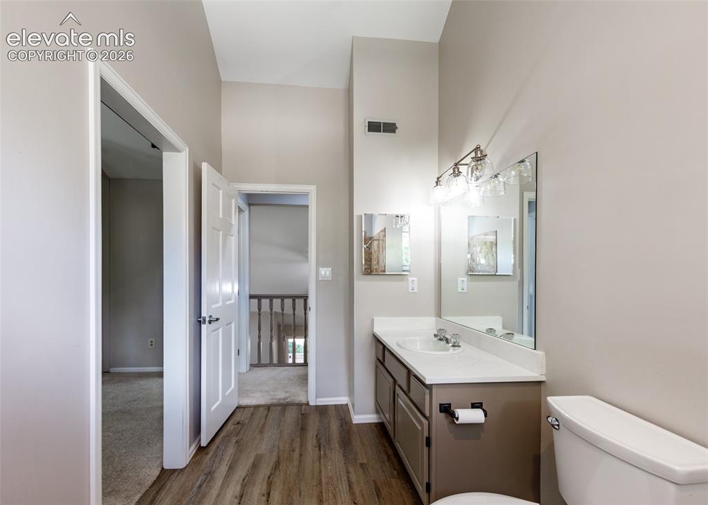 Image 34 of 44: Bathroom featuring wood-finish flooring, a single vanity with a white count