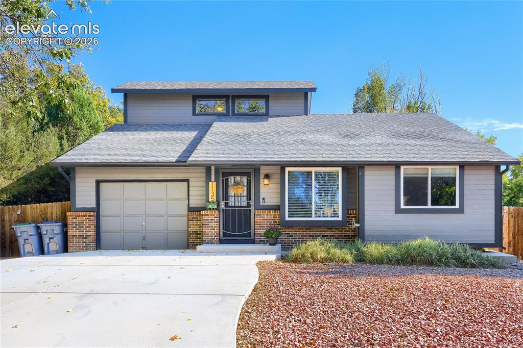 Image 1 of 19: Exterior featuring brick accents, horizontal siding, an attached garage, an