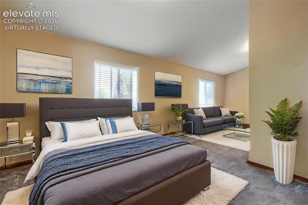 Image 11 of 19: Virtually Staged - Expansive room with neutral tone walls and multiple wind