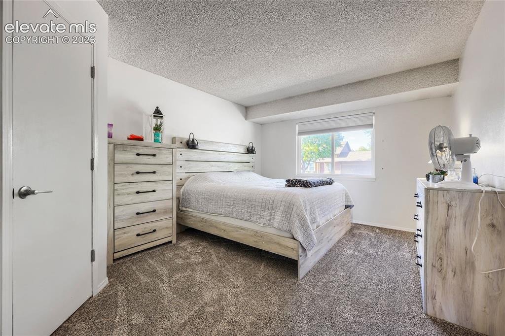 Image 13 of 19: Carpeted flooring with white painted walls and a single window