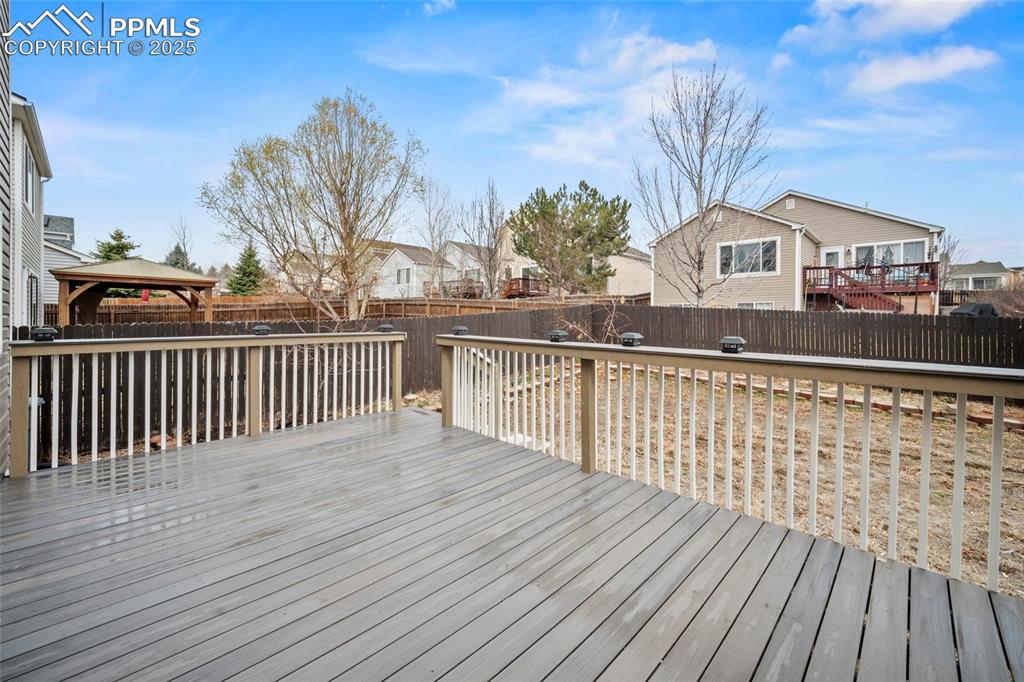 Image 9 of 43: Deck with a fenced backyard, a residential view, and a gazebo