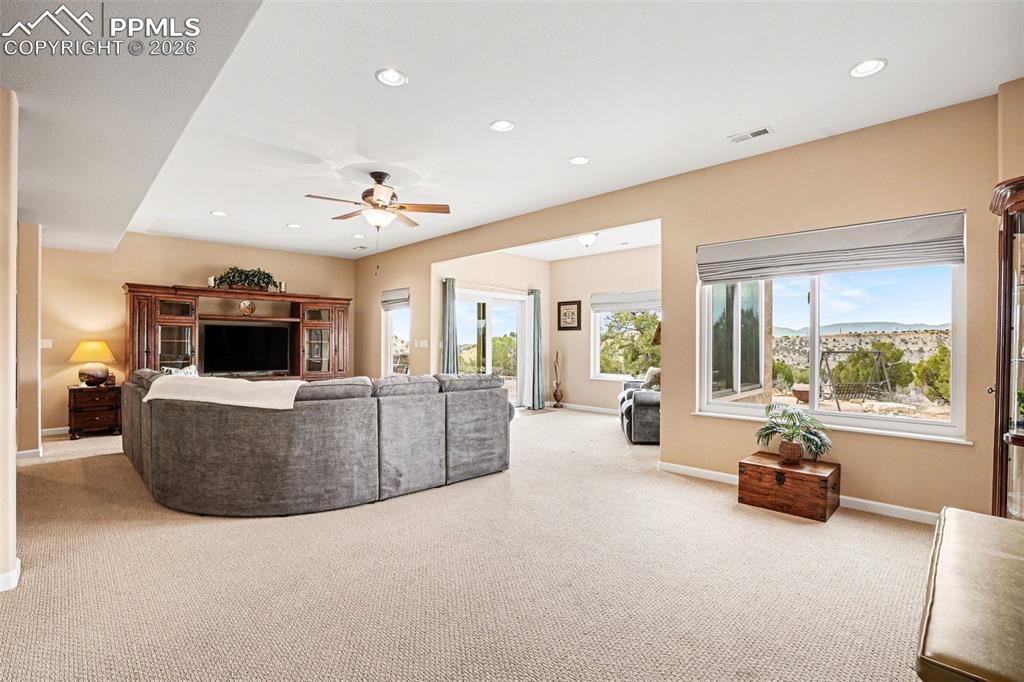 Image 24 of 47: The finished walk-out basement features a large family room perfect for ent