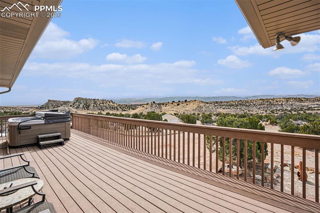 Image 31 of 47: The upstairs Trex deck is perfect for relaxation and entertaining, featurin