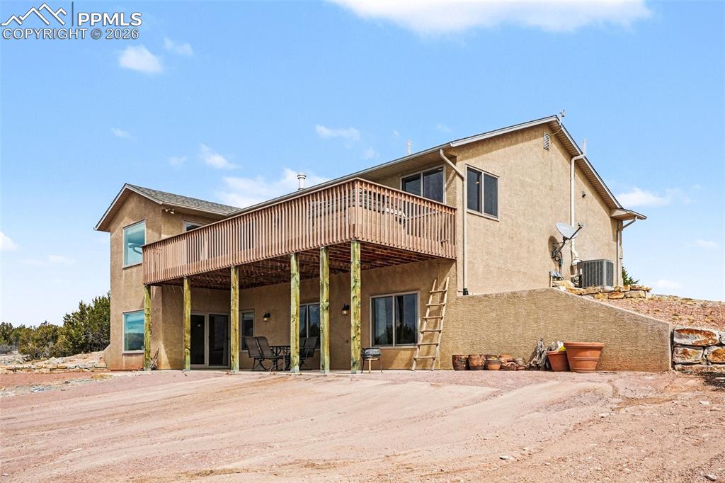 Image 34 of 47: The back of the home features a walk-out basement with access to a concrete