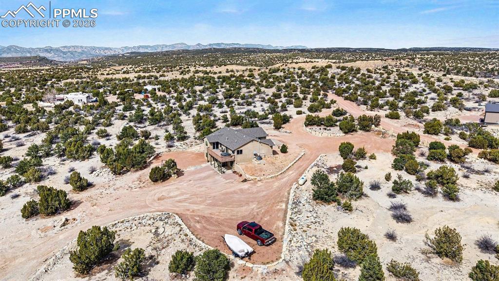 Image 43 of 47: From an aerial perspective, the nearly 40-acre property showcases the custo