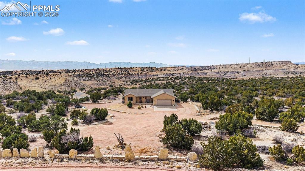 Image 8 of 47: property showcases nearly 40 acres of open land, with the custom stucco ran
