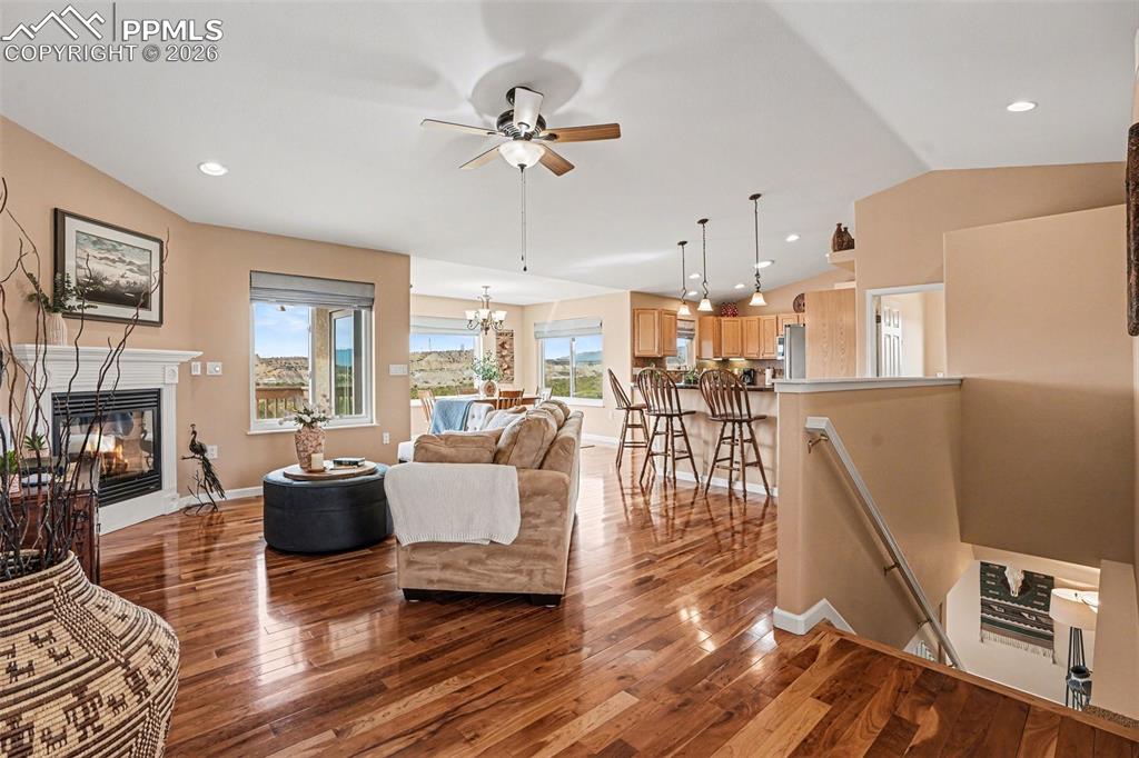 Image 9 of 47: The living room features vaulted ceilings and beautiful cherry hardwood flo