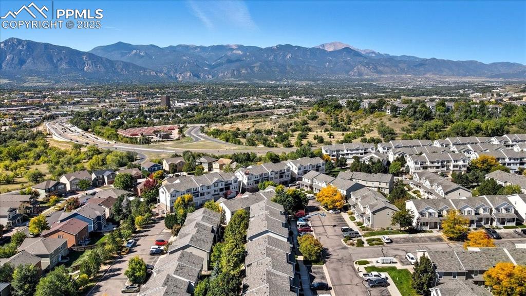 Image 33 of 36: Aerial view of residential area with a mountain backdrop