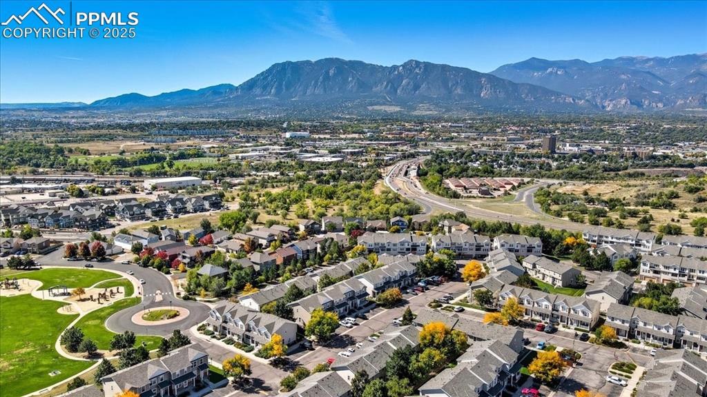 Image 34 of 36: Aerial view of residential area featuring mountains