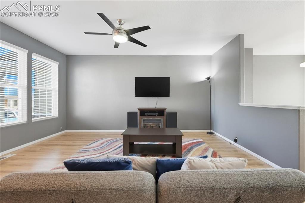 Image 5 of 36: Living room featuring wood finished floors and a ceiling fan