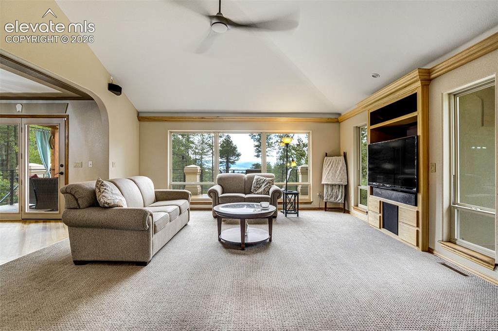 Image 10 of 40: Spacious primary living area featuring expansive windows and glass sliding