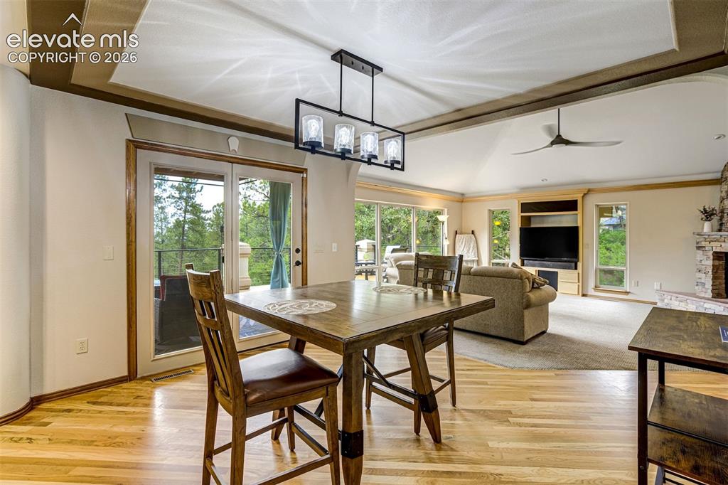 Image 17 of 40: Hardwood flooring, tray ceiling, sliding glass doors to a balcony, vaulted 