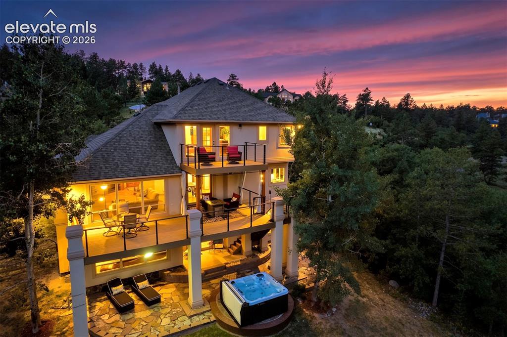 Image 4 of 40: Multi-level exterior with multiple balconies, a ground-level patio, and an 