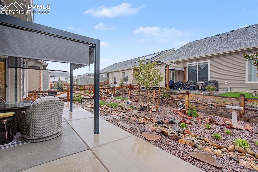 Image 22 of 26: Covered Louvered Pergola with shades for 3 sides for privacy